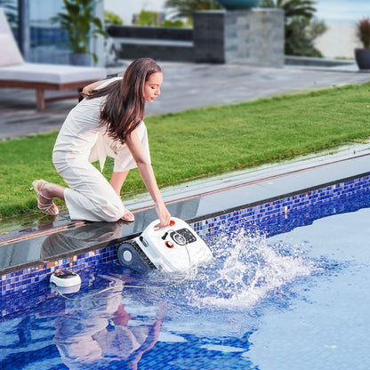 Woman operating a pool cleaning robot by a poolside